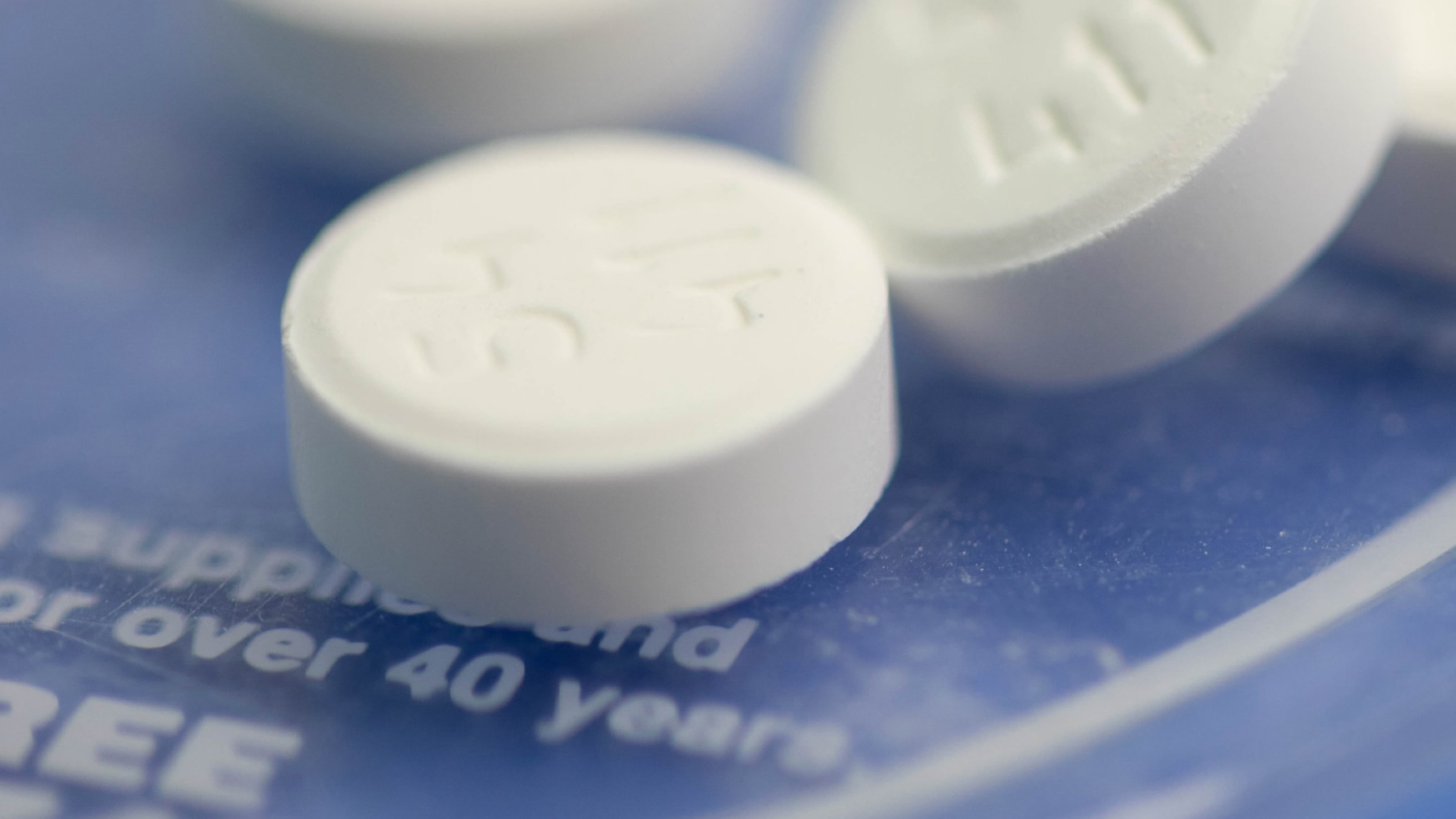 Pills scattered on a blue surface